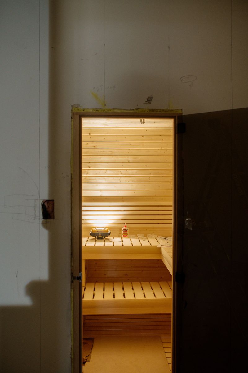 A cedar sauna going in at a home under construction in Urbandale, with slatted benches built into the wall.