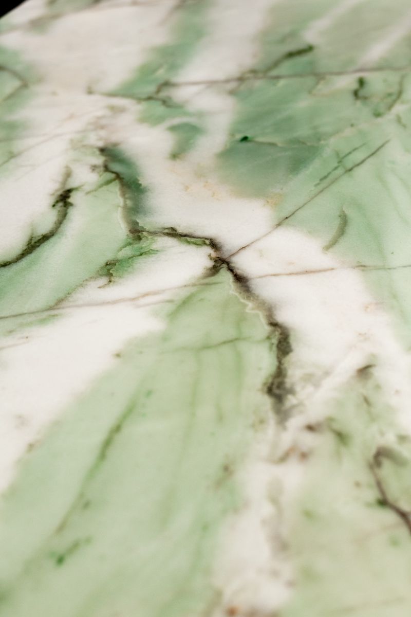 A green and white marble slab in Des Moines, with soft green veining running through a polished white stone.